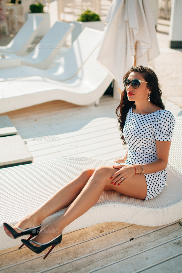 fashion luxury long legged lady model on sunbed Stock Photo by